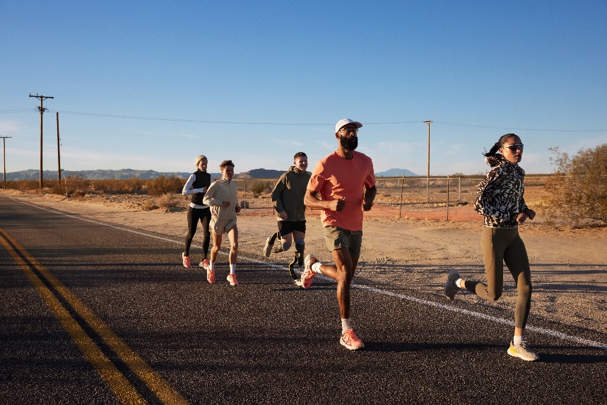 A group of people running on a road

Description automatically generated