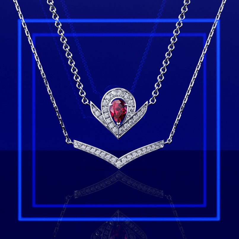 A necklace with a red gem

Description automatically generated