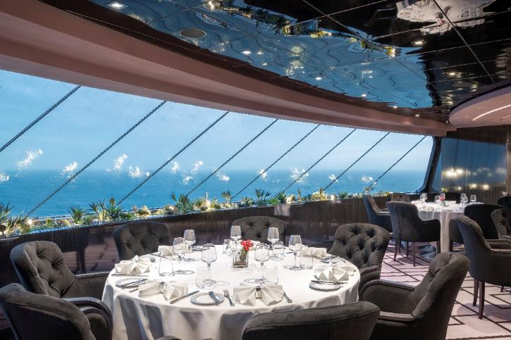 A restaurant with a view of the ocean Description automatically generated