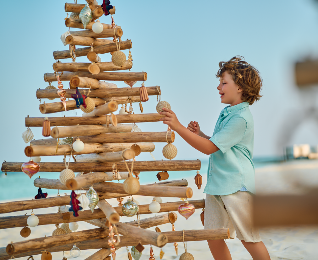 A child standing next to a tree made of wood

Description automatically generated