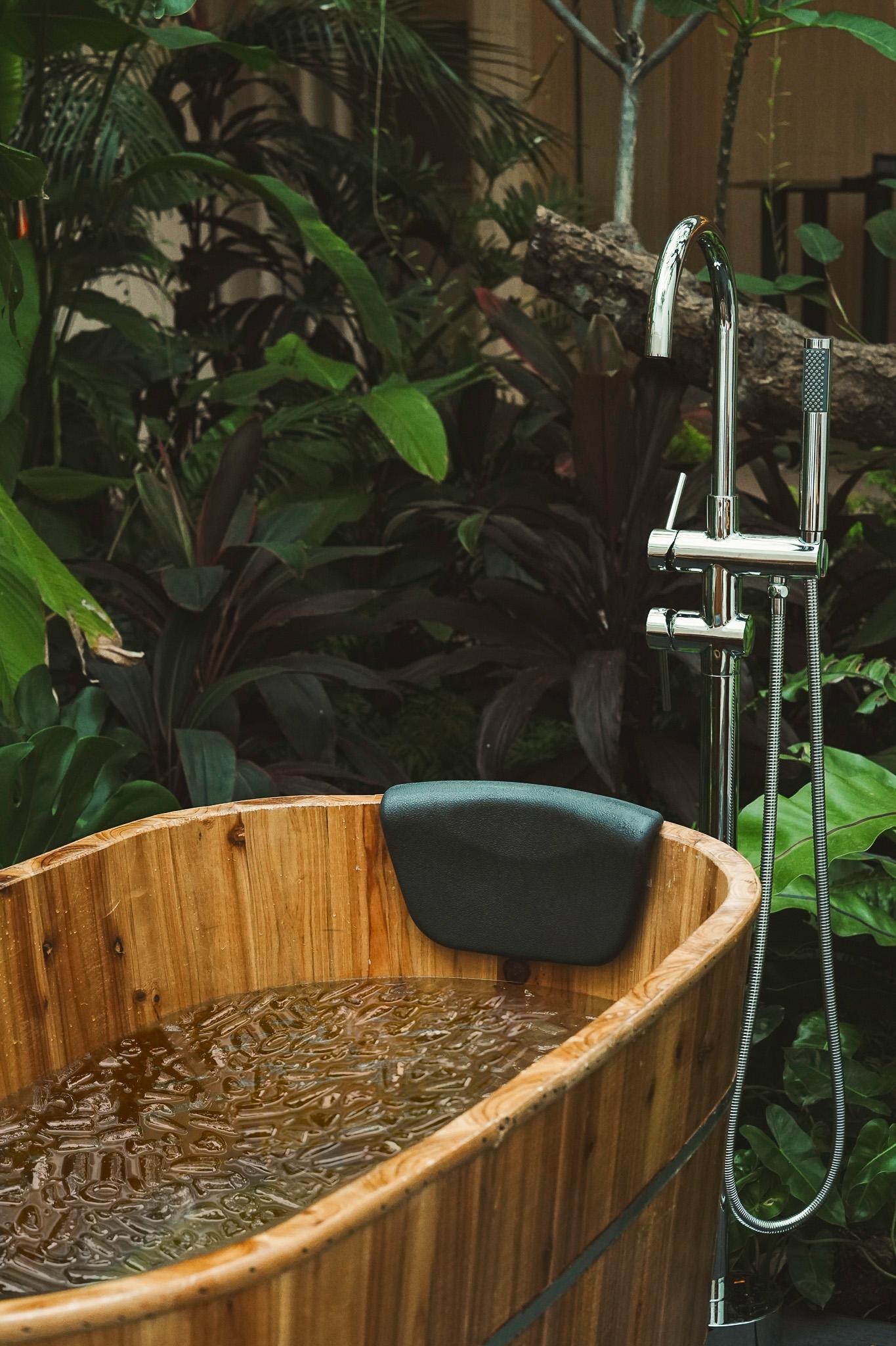 A wooden bathtub with water in it

AI-generated content may be incorrect.