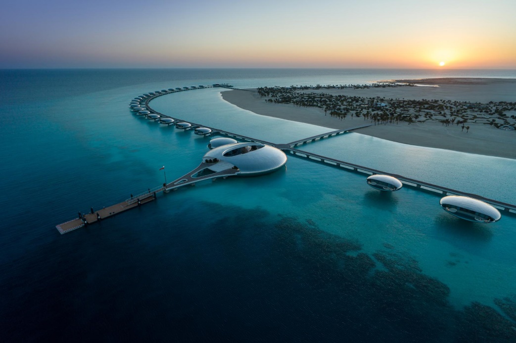 A bridge over water with buildings and a beach

AI-generated content may be incorrect.