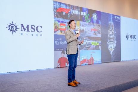 A person standing in front of a large screen AI-generated content may be incorrect.
