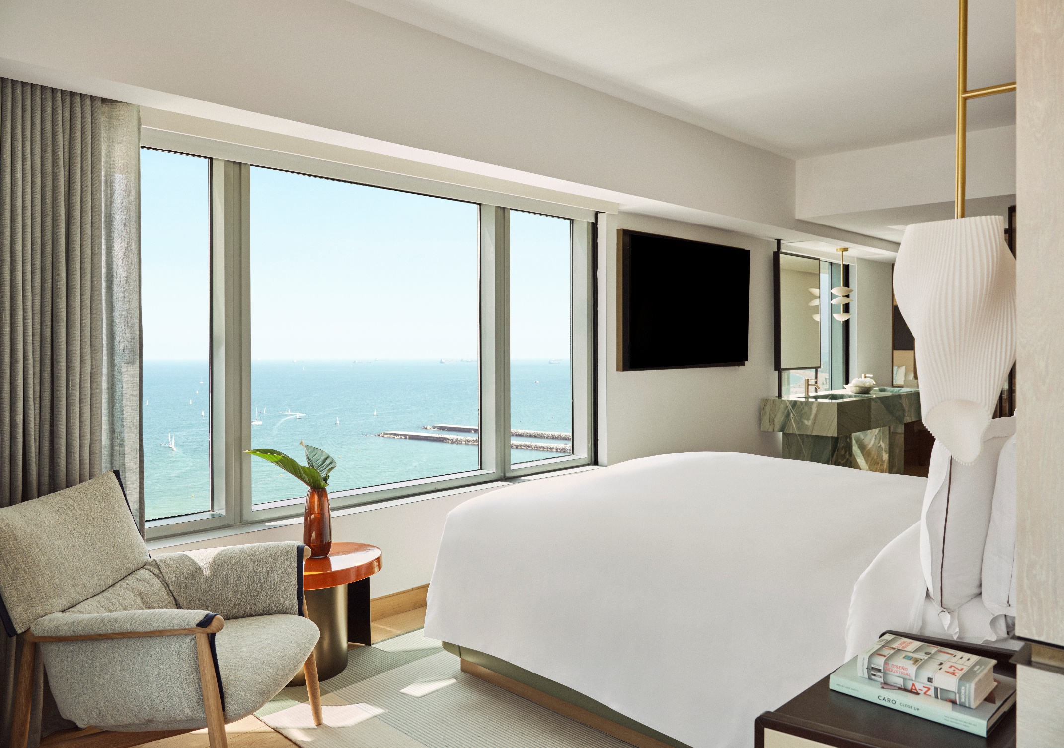A room with a large window overlooking the ocean

AI-generated content may be incorrect.