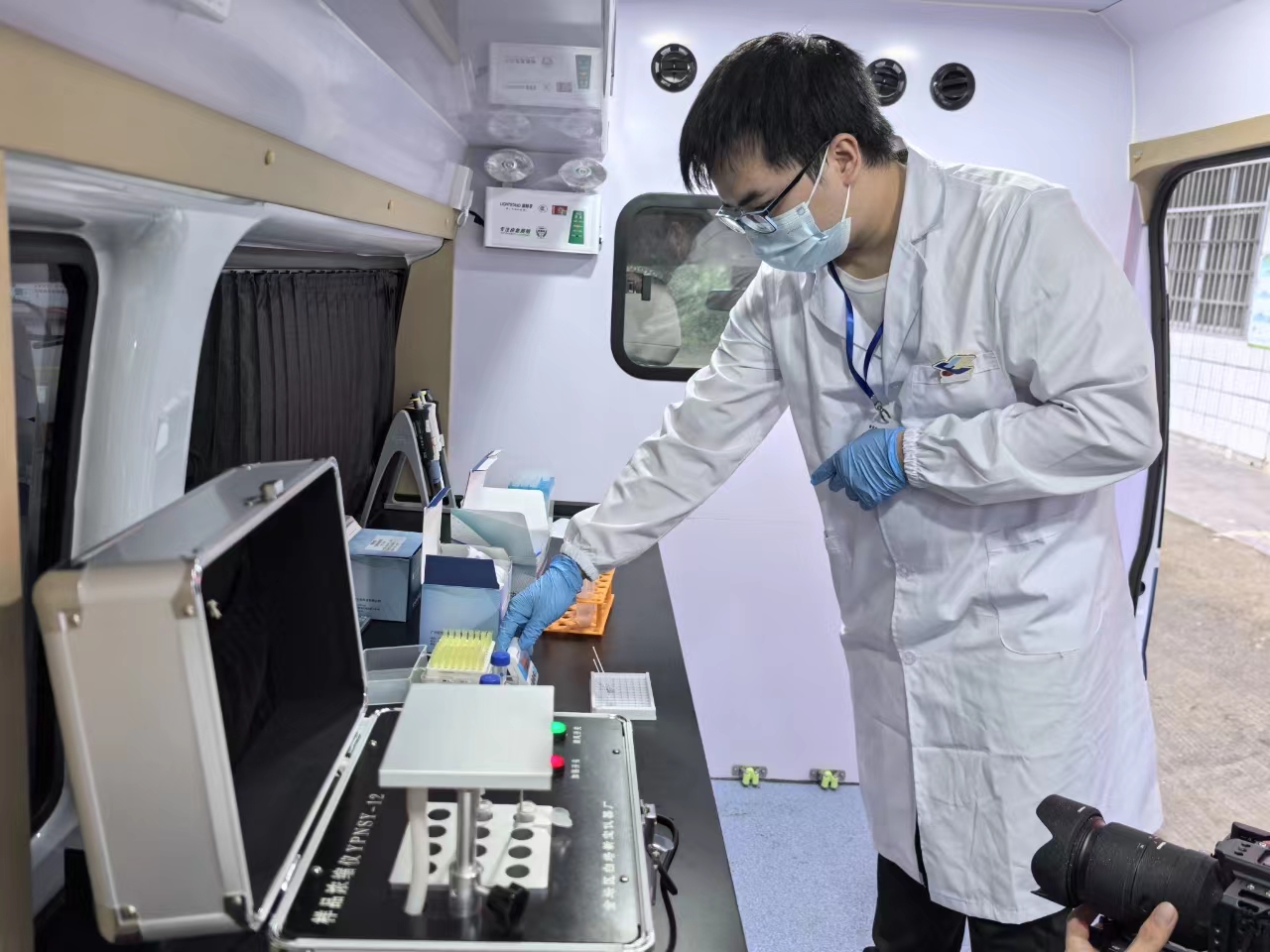 A person wearing a mask and gloves AI-generated content may be incorrect.