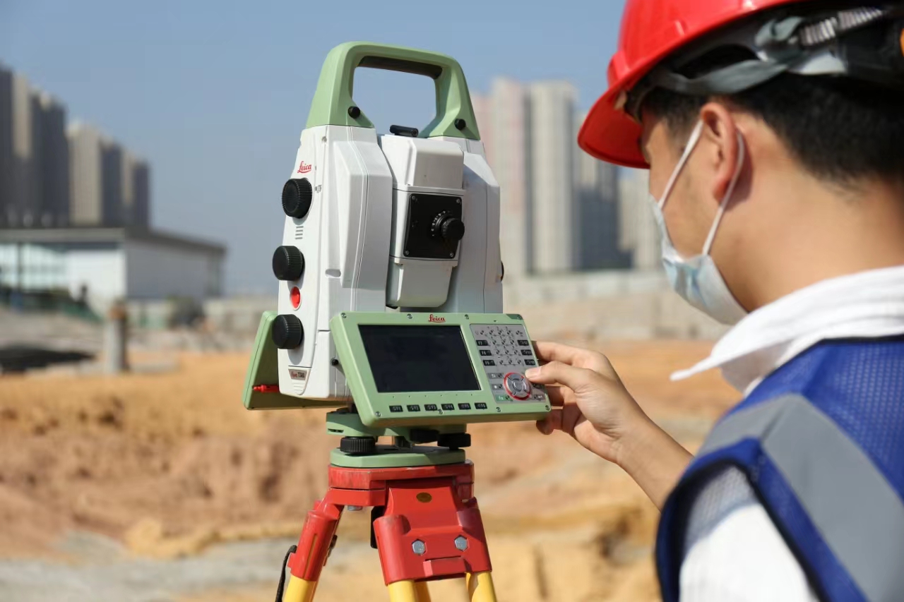 A person using a theodolite AI-generated content may be incorrect.
