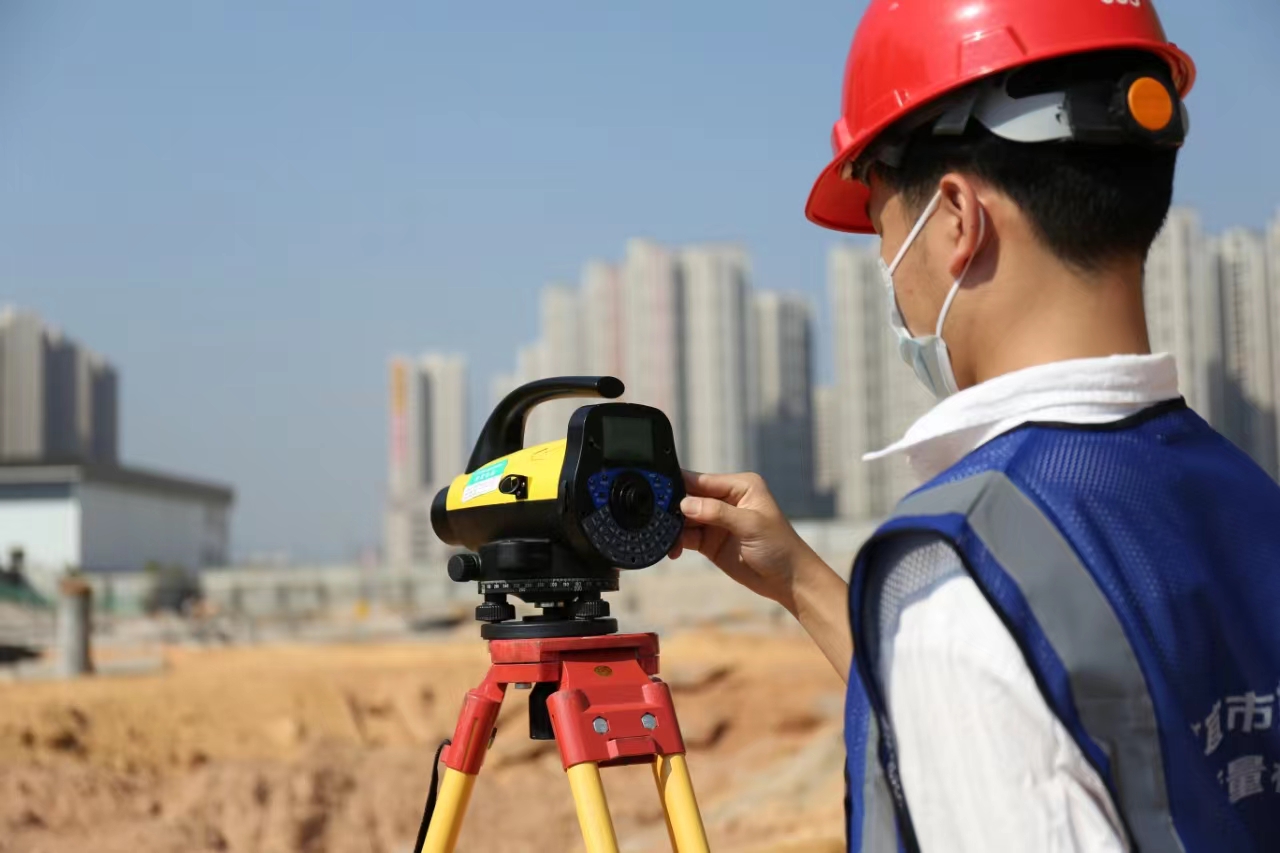 A person using a theodolite AI-generated content may be incorrect.