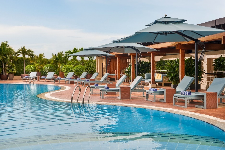 A pool with chairs and umbrellas

AI-generated content may be incorrect.