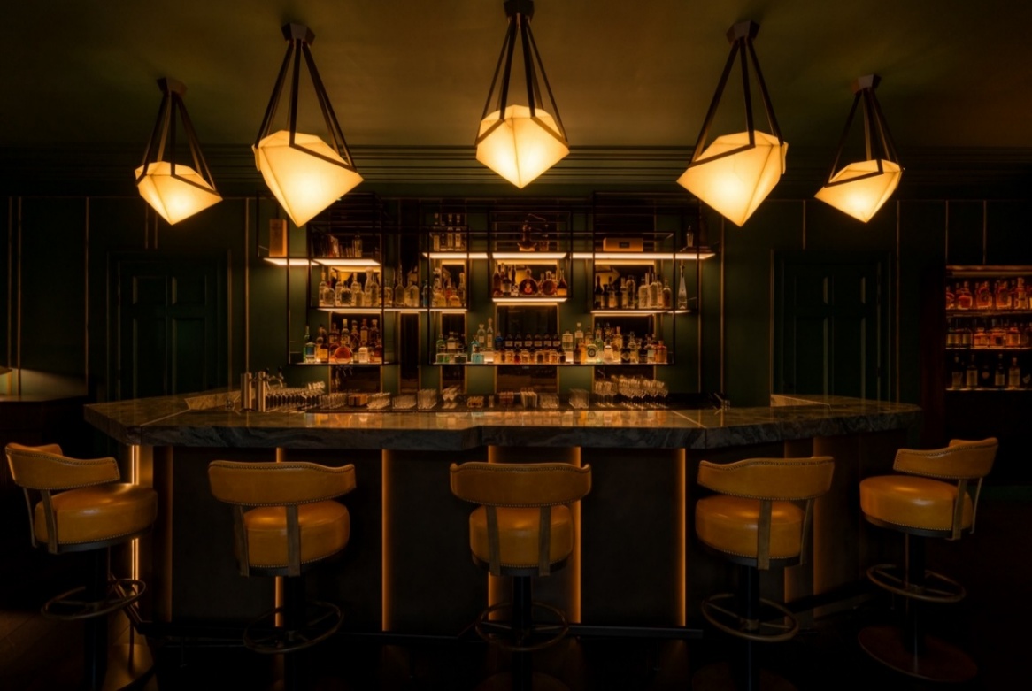 A bar with lights from the ceiling
AI-generated content may be incorrect.