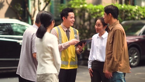 A group of people standing around each other AI-generated content may be incorrect.