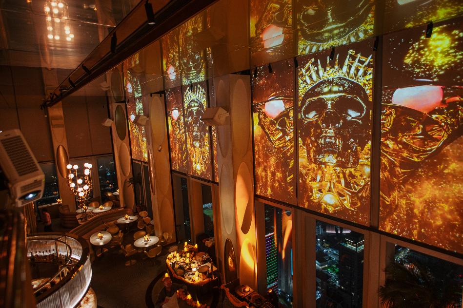 A room with a large screen with a skull and crown AI-generated content may be incorrect.
