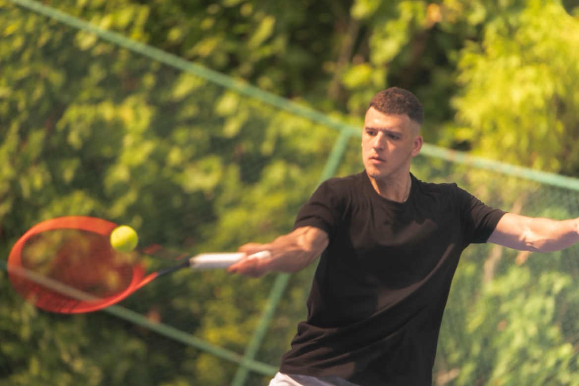A person swinging a tennis racket AI-generated content may be incorrect.